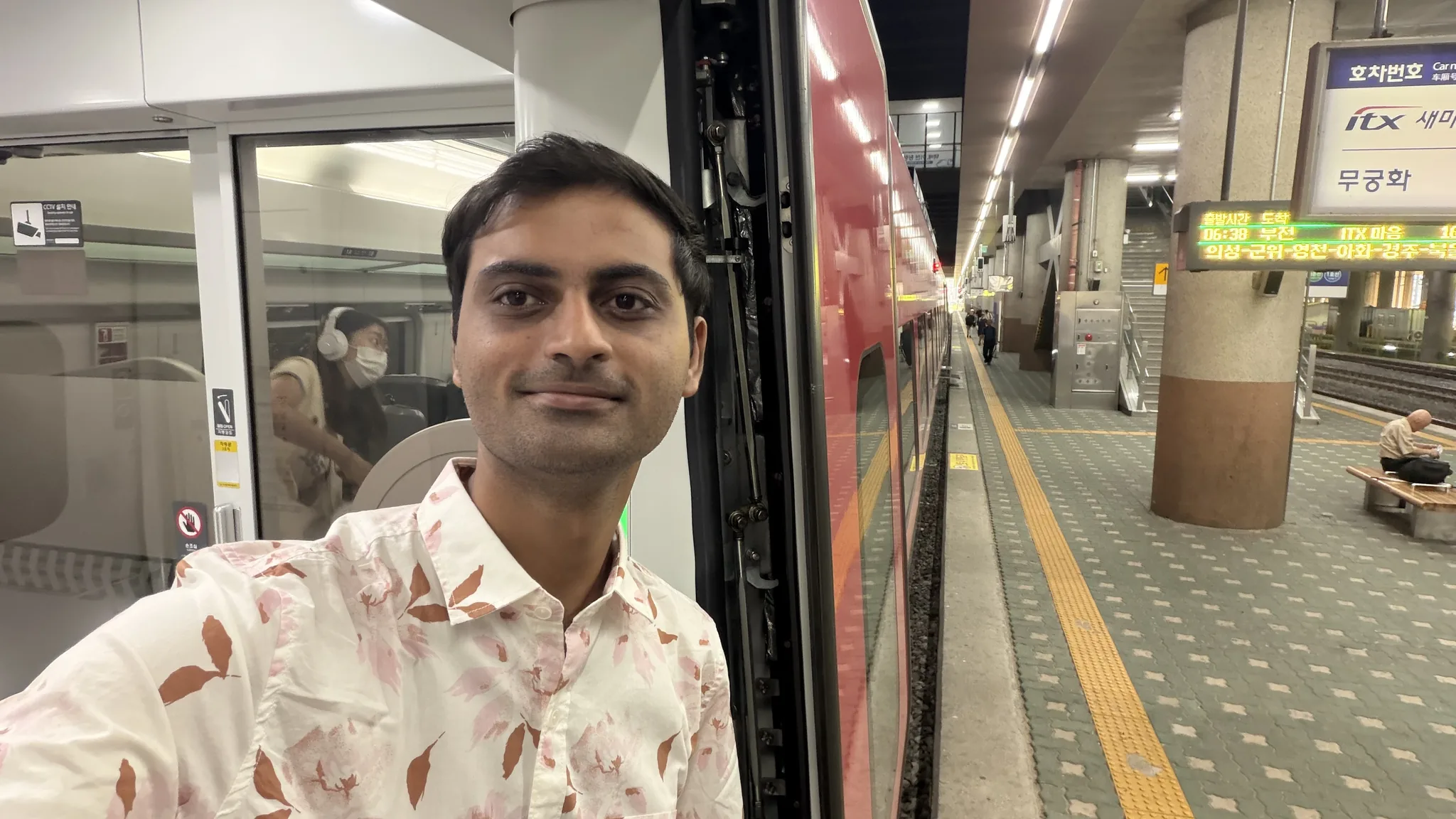 Yogendra Manawat beside a train at a station in South Korea