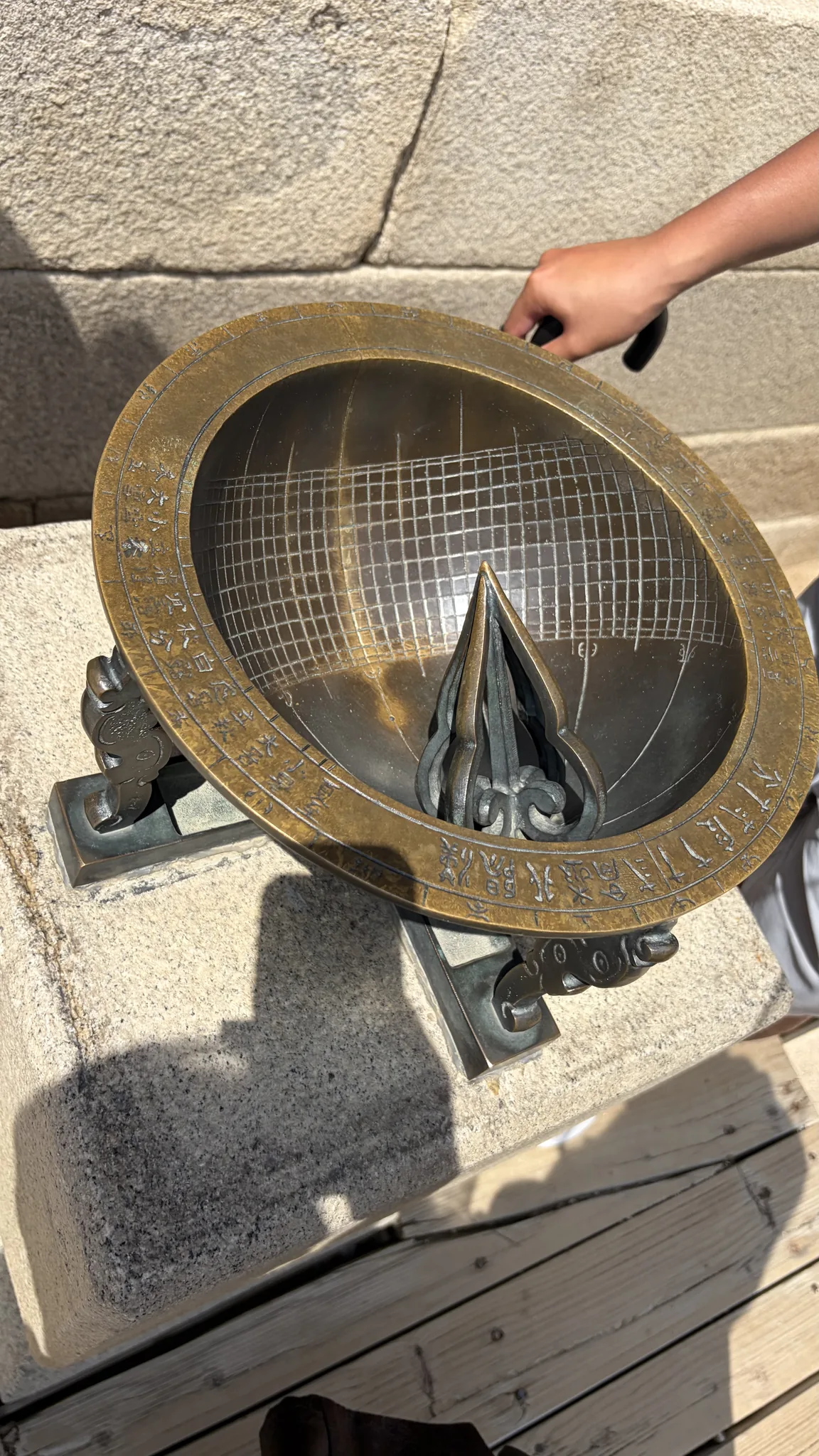 A round Joseon-era sundial with its shadow marker