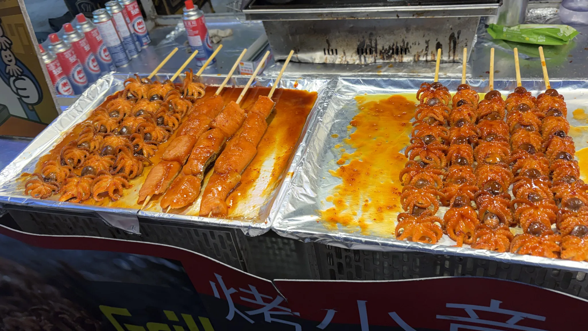 Street food skewers cooking at a Myeongdong stall